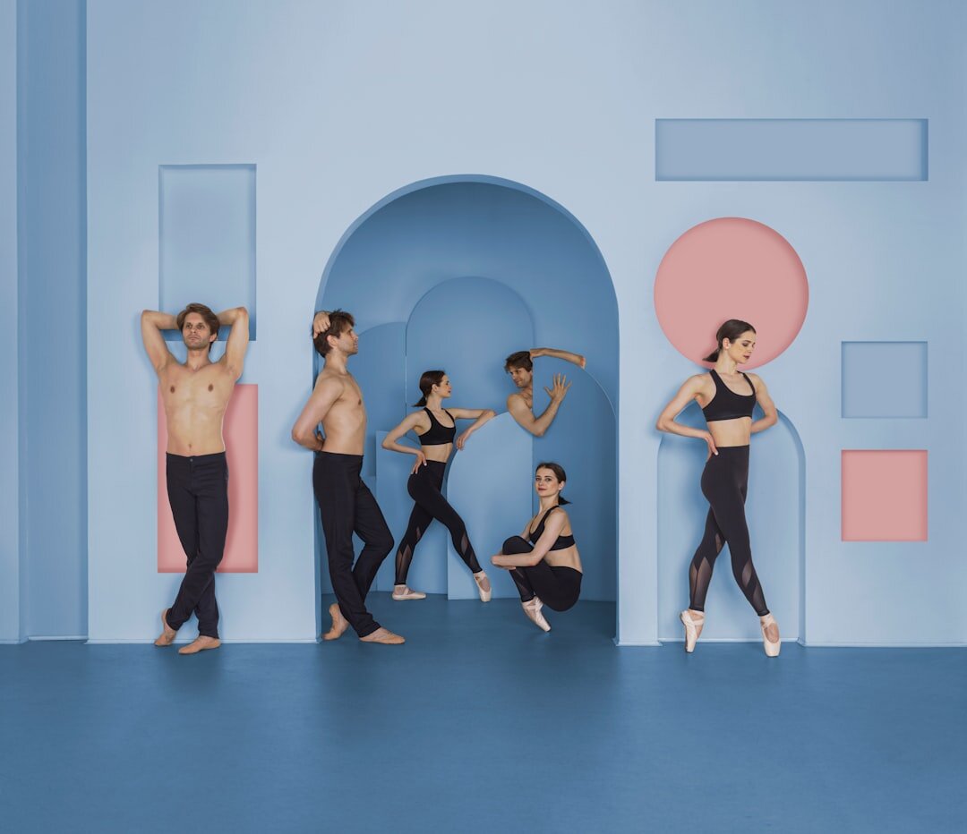 Group of diverse people practicing voice and body exercises in a bright studio
