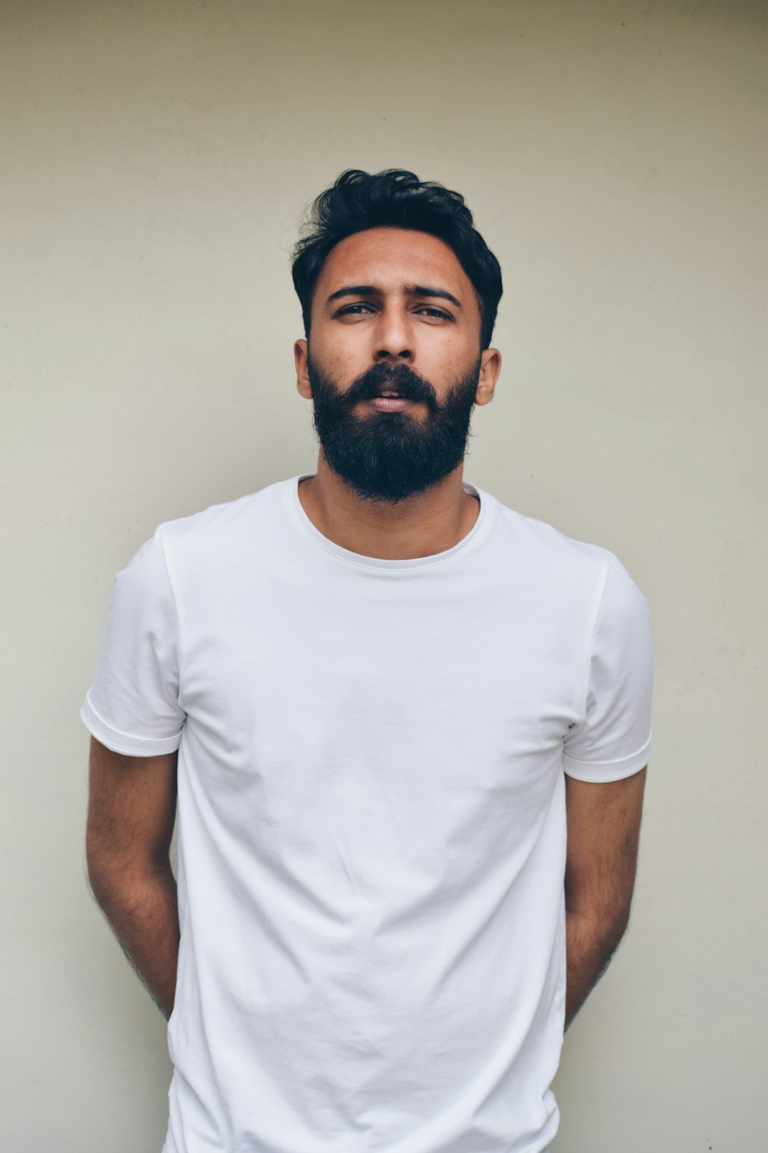 Studio portrait of a man with short beard and calm expression